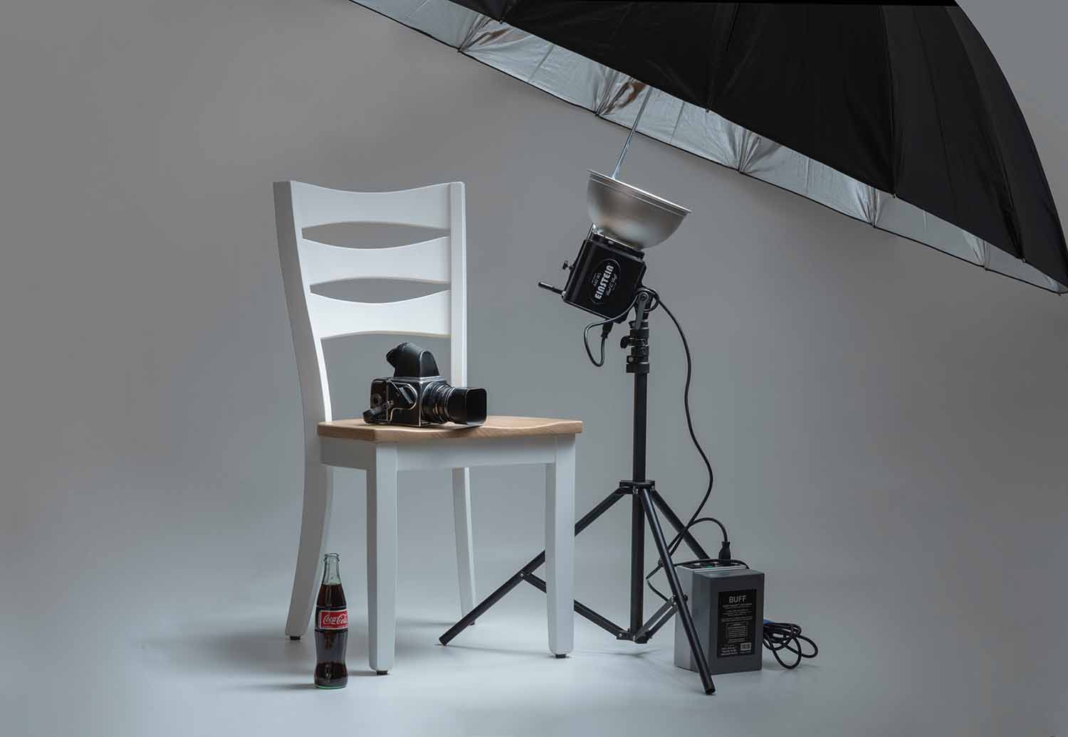 a chair and a chair with a camera and a bottle of soda